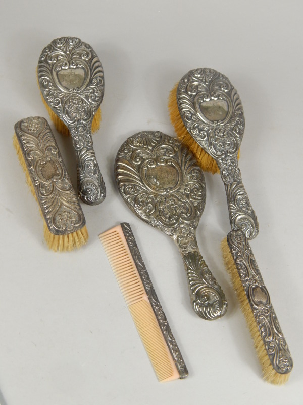 Appraisal: A Victorian silver backed dressing table set heavily embossed decoration