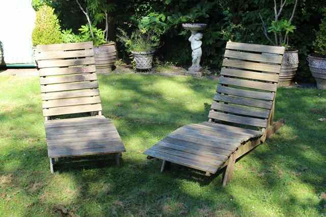 Appraisal: A PAIR OF TEAK ADJUSTABLE SINGLE SUN LOUNGERS