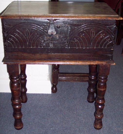 Appraisal: An oak bible box with plain hinged cover carved panelled