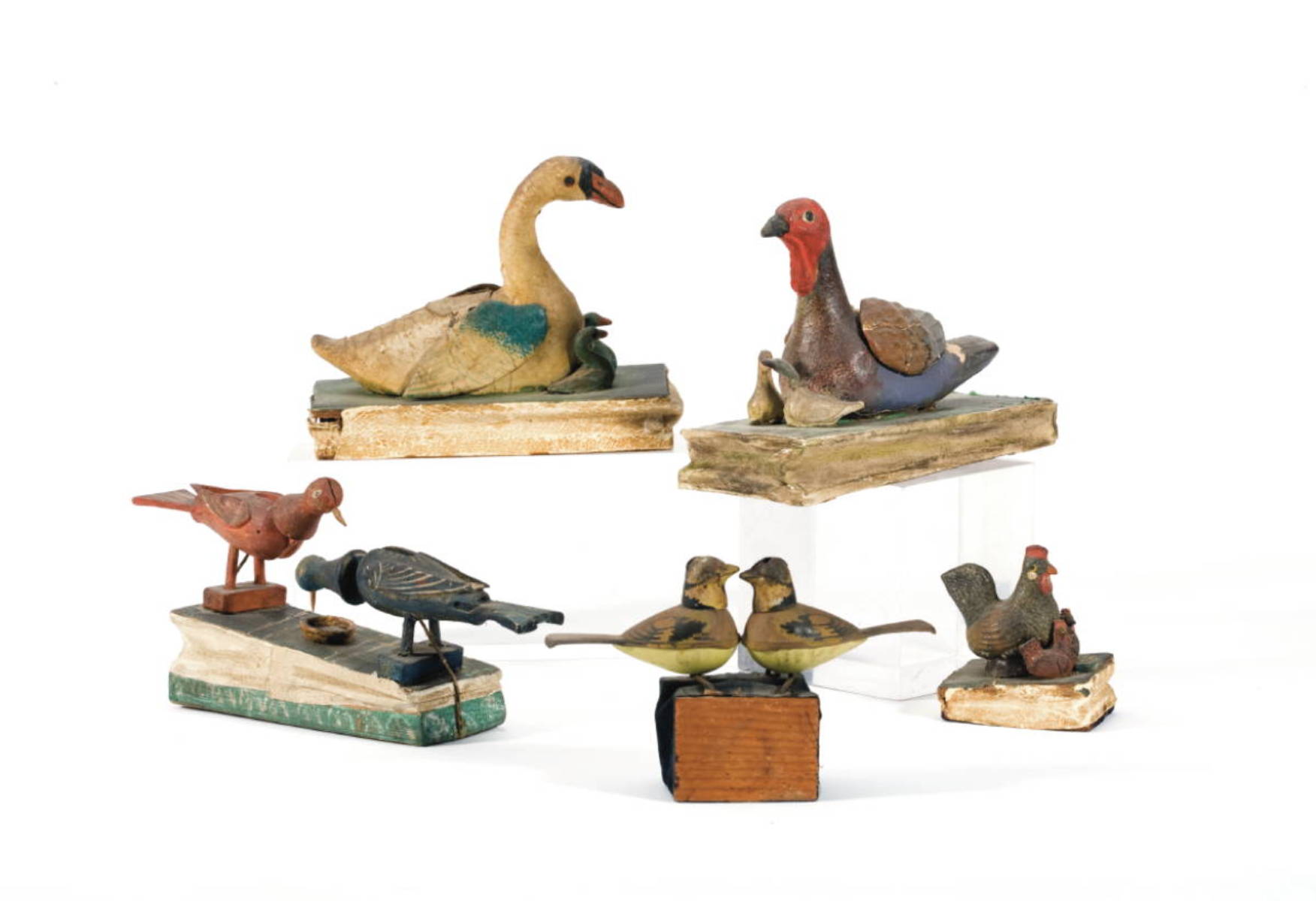 Appraisal: FOUR PAINTED PAPIER MACHE WOOD AND LEATHER BIRD SQUEAK TOYS