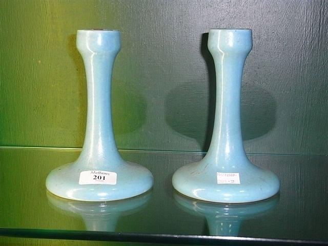 Appraisal: A PAIR OF RUSKIN POTTERY BLUE LUSTRE GLAZED CANDLESTICKS with