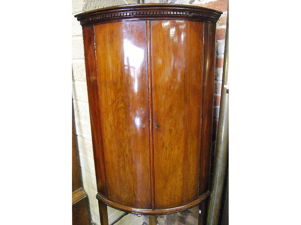 Appraisal: A George III mahogany barrel front hanging corner cupboard the