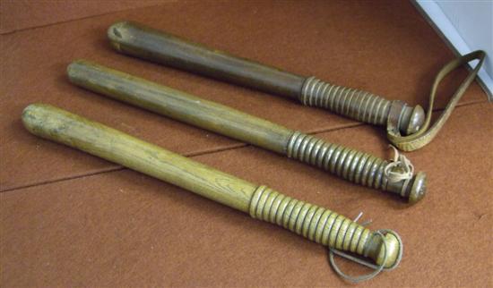 Appraisal: Three mahogany truncheons with turned handles the largest