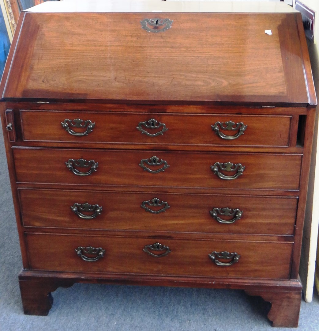 Appraisal: A George III mahogany bureau the fall enclosing a fitted