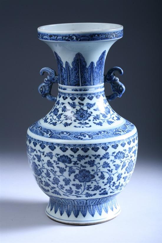 Appraisal: CHINESE BLUE AND WHITE PORCELAIN VASE With floral decoration dragonhead-form