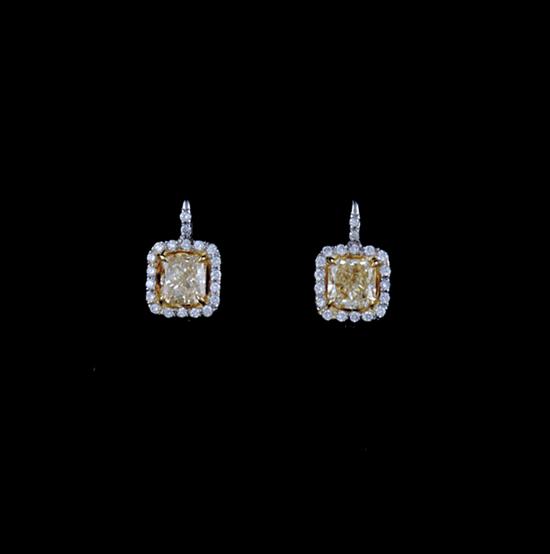 Appraisal: Yellow diamond and platinum drop earrings each centered by radiant-cut