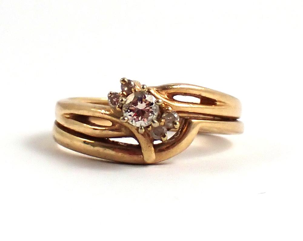 Appraisal: DIAMOND AND FOURTEEN KARAT GOLD RING accented with four round-cut