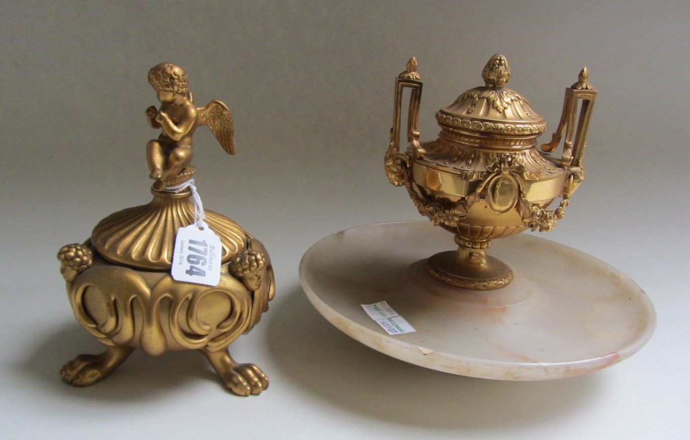 Appraisal: A gilt bronze inkwell of two handled urn form raised