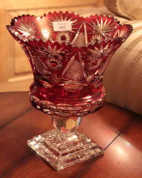 Appraisal: A RUBY FLASH GLASS VASE with shaped flaring rim faceted