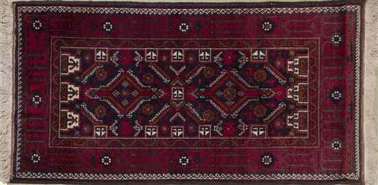 Appraisal: A Northwest Persian Wool Rug having twin geometric medallions on