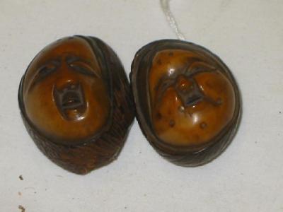 Appraisal: TWO JAPANESE NETSUKE each carved from a walnut with a