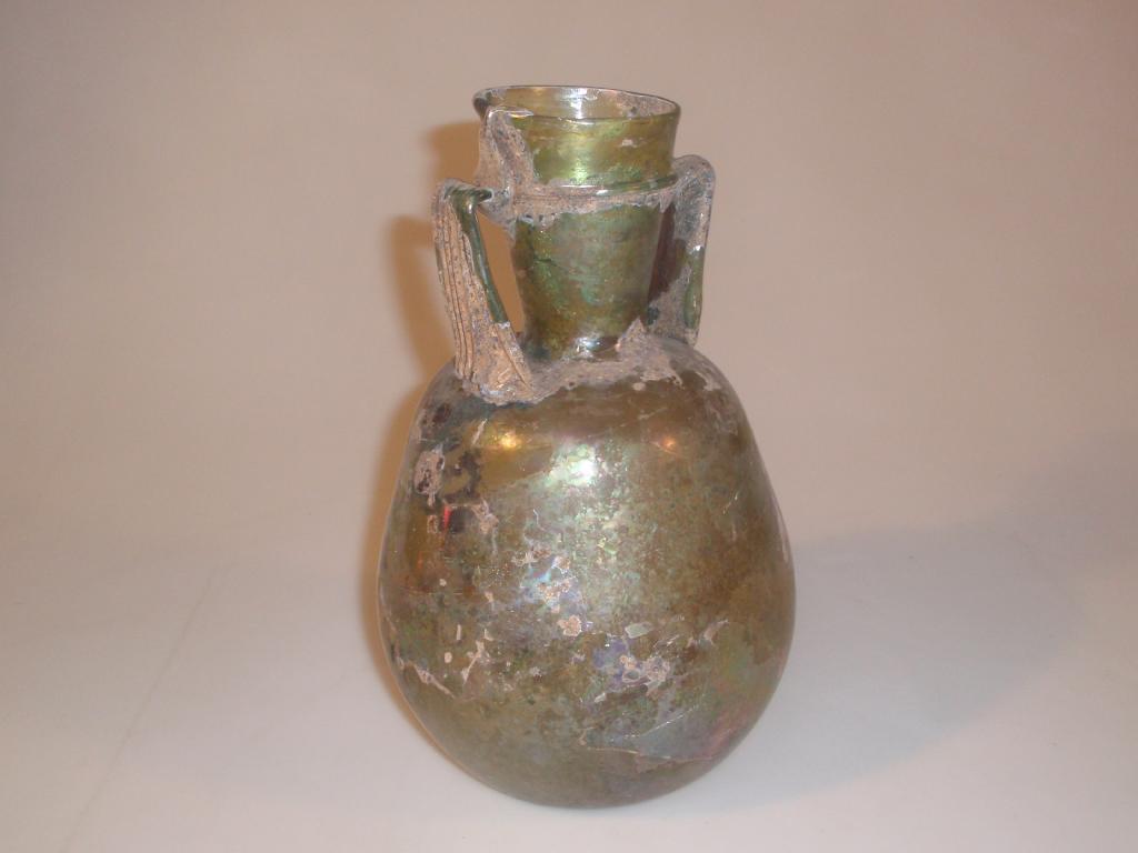 Appraisal: A large post-Roman light green glass amphora the funnel neck