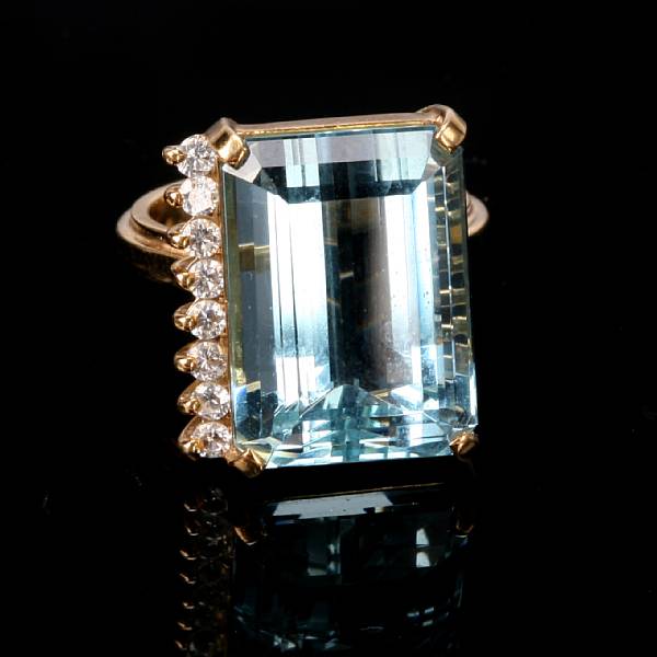 Appraisal: An aquamarine diamond and eighteen karat yellow gold ring centering