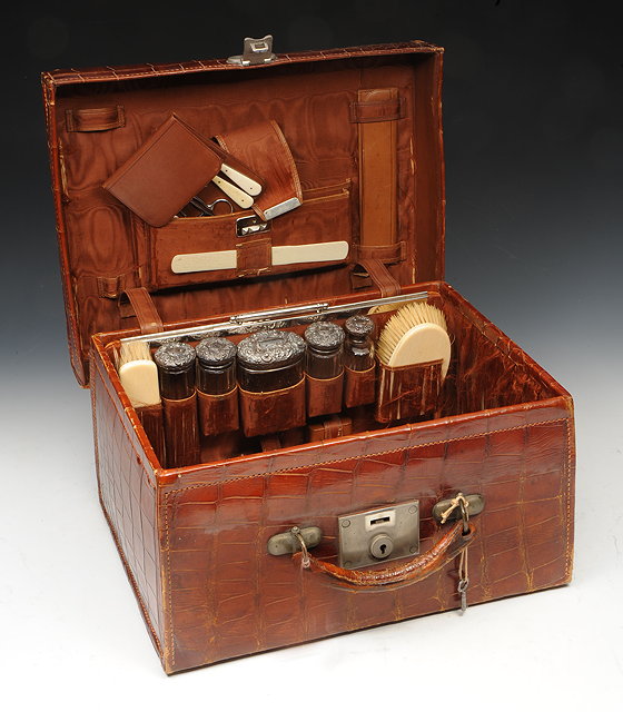 Appraisal: AN EDWARDIAN CROCODILE SKIN GENTLEMAN'S TRAVELLING CASE with various jars