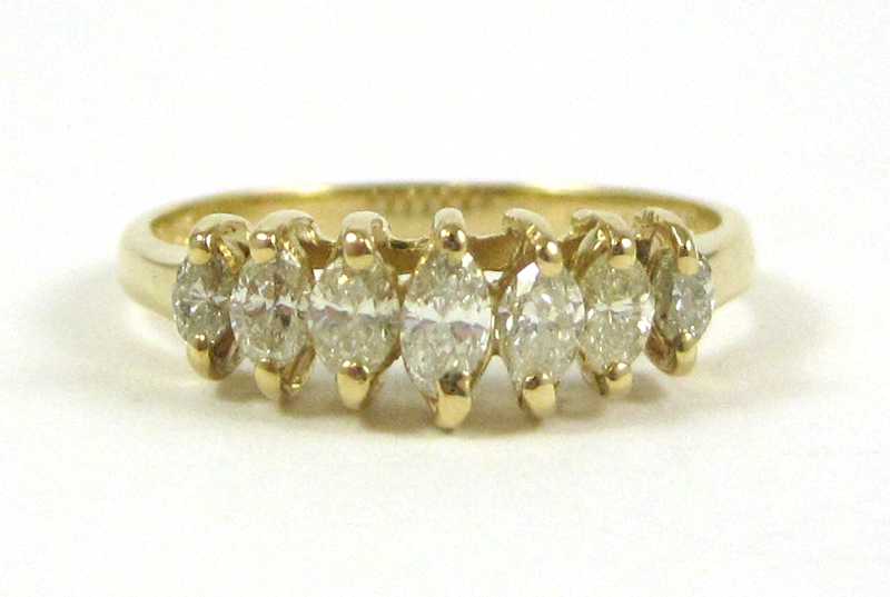 Appraisal: DIAMOND AND FOURTEEN KARAT GOLD RING set with seven marquise-cut