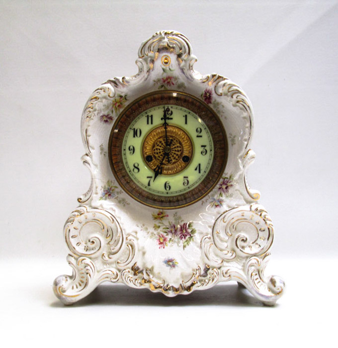 Appraisal: WATERBURY CHINA MANTLE CLOCK with white glaze and floral affectation