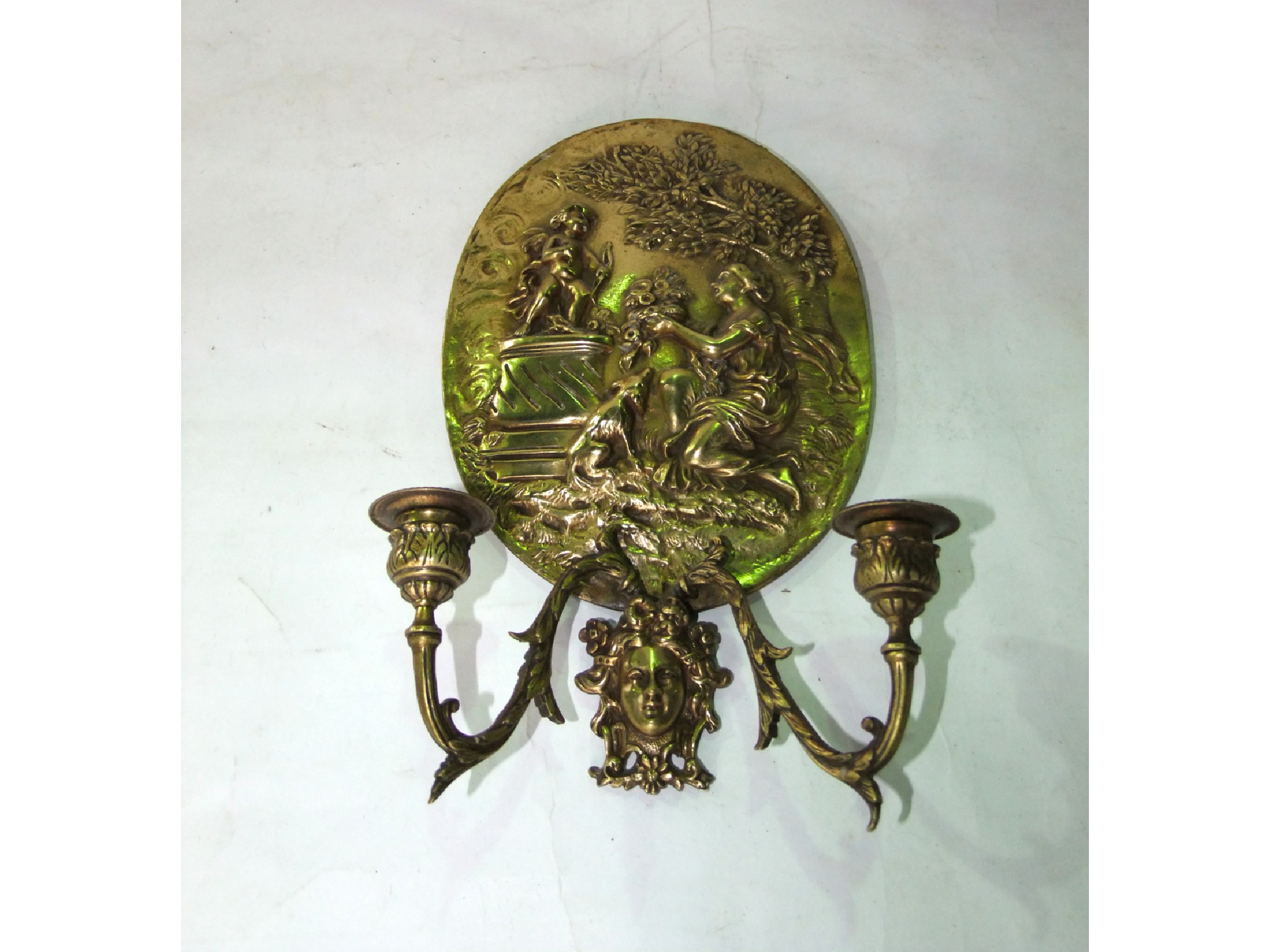 Appraisal: A brass two divisional wall sconce the oval shaped backing