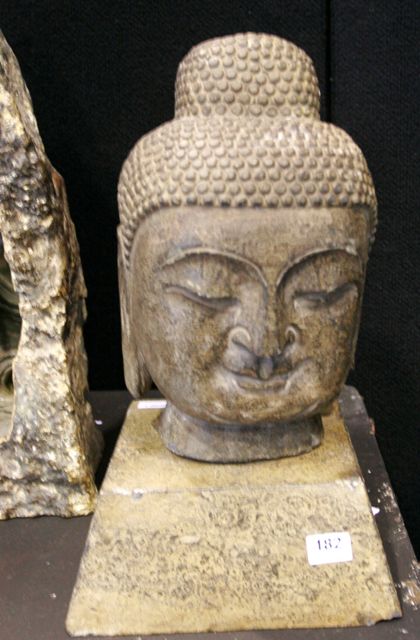 Appraisal: A pair of th century carved stone Buddha heads on