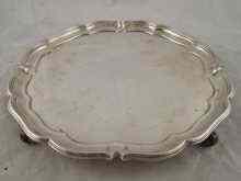 Appraisal: A silver salver hallmarked London by Asprey on scroll feet