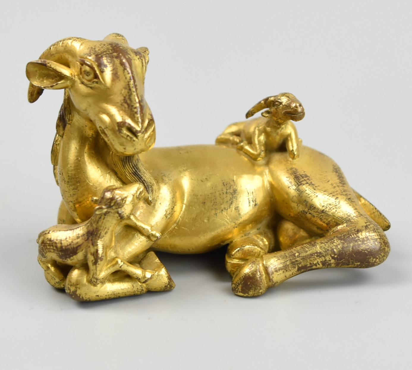 Appraisal: CHINESE GILT BRONZE PAPERWEIGHT GOAT STATUE QING D the recumbent