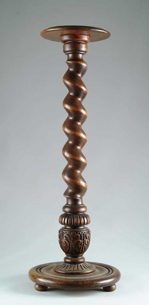 Appraisal: TALL CARVED WOOD PEDESTAL molded edge round top supported by