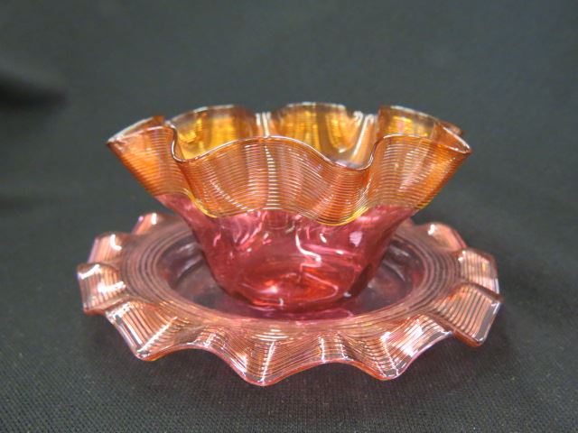 Appraisal: Cranberry Art Glass Bowl and Underplate fireglow style threading Stevens