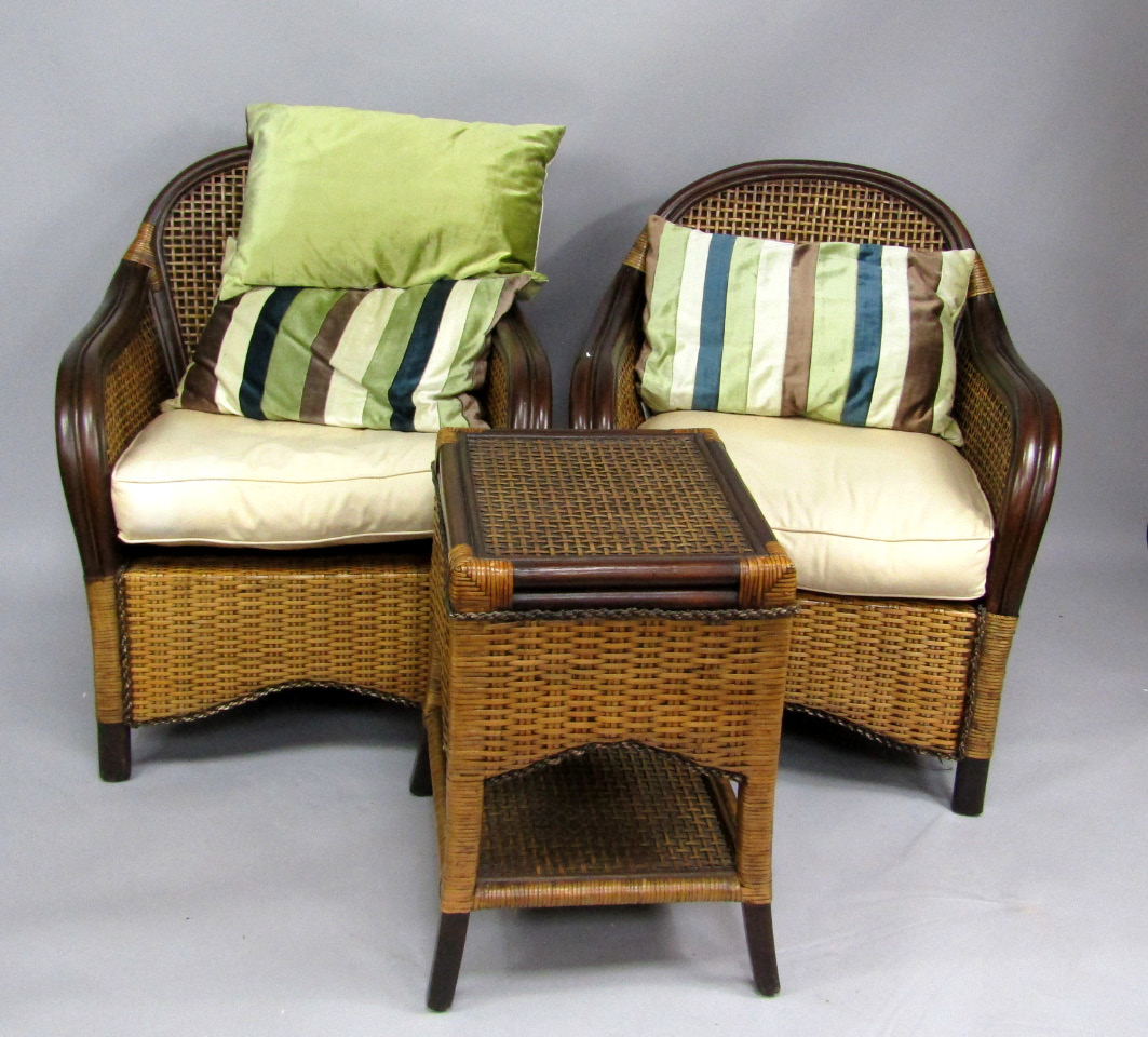 Appraisal: A pair of Indonesian woven cane armchairs with loose cushions