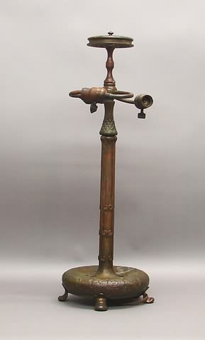 Appraisal: Shaft with multiple tendrils and coils lights circular base with