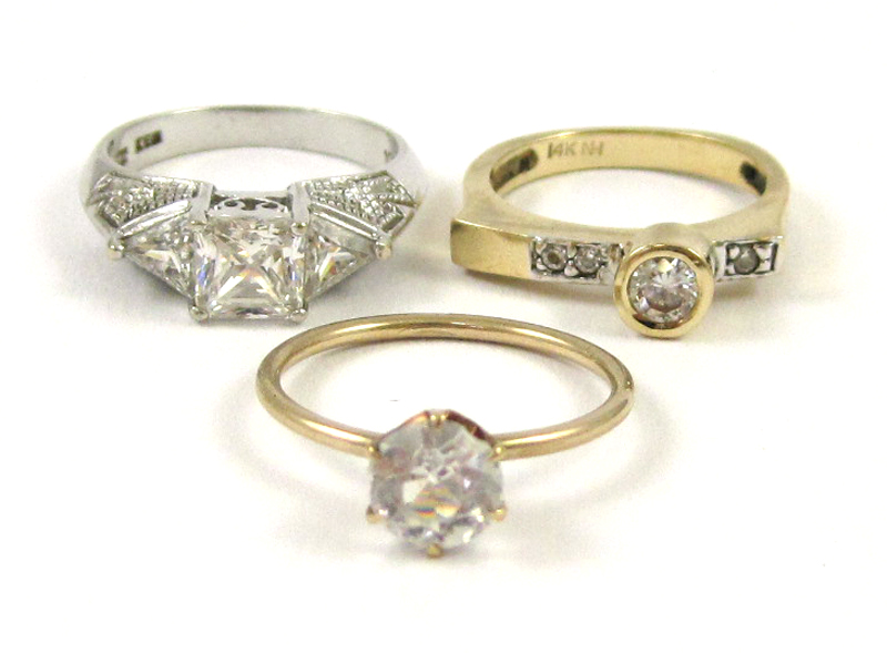 Appraisal: THREE FAUX DIAMOND AND GOLD RINGS including a size k