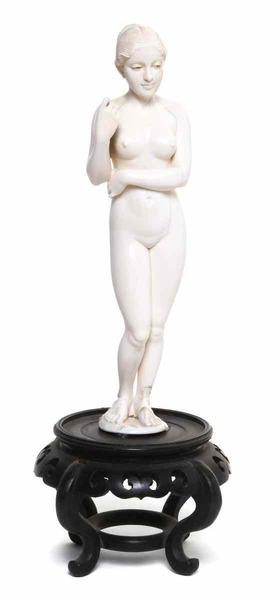 Appraisal: A Continental Carved Ivory Figure depicting a standing nude female