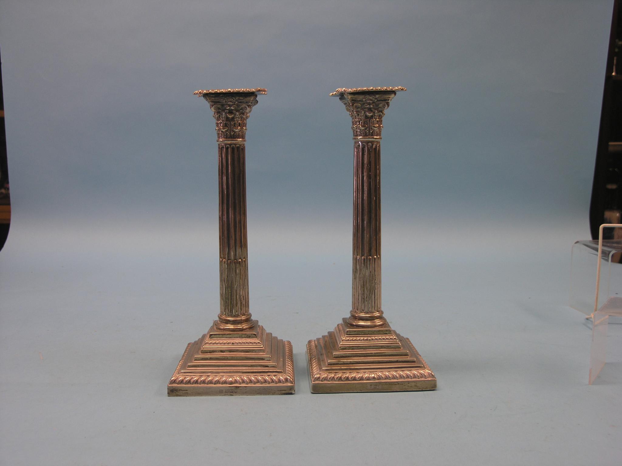 Appraisal: A pair of Edward VII silver Corinthian column candlesticks with