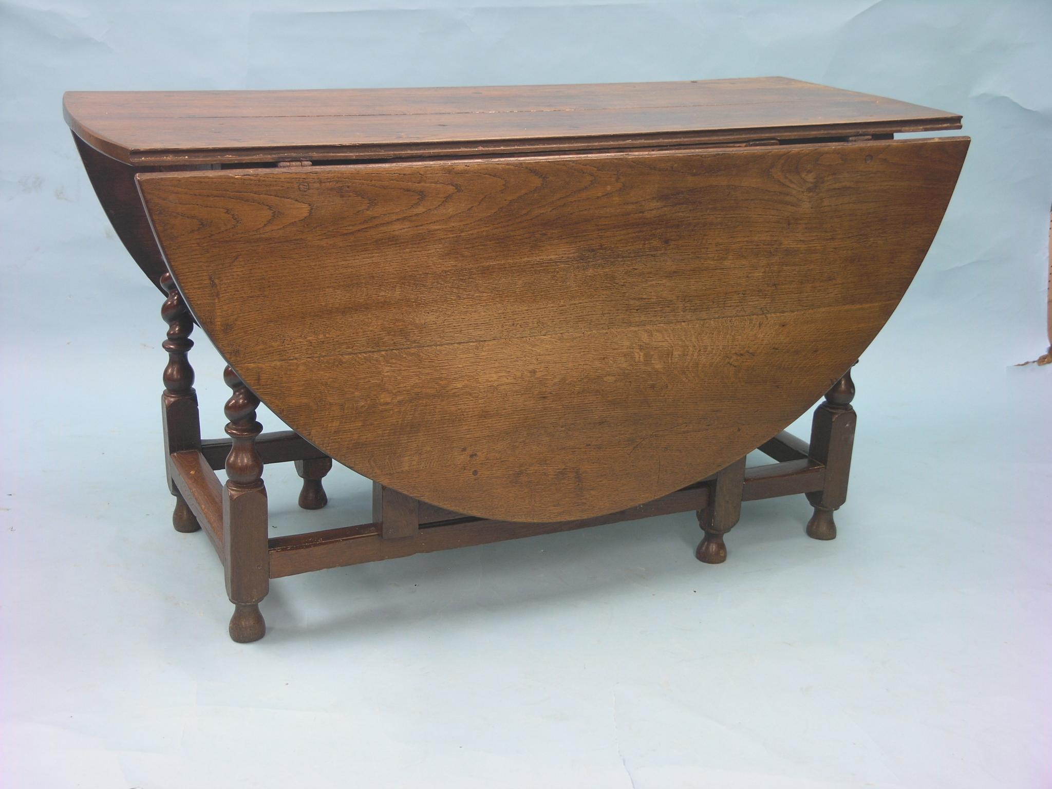 Appraisal: A large early th century oak gateleg table on barley-twist