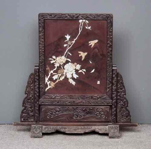 Appraisal: A Japanese carved and stained wood framed red lacquer and