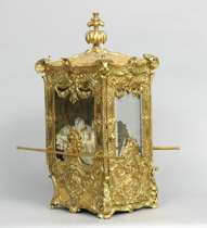 Appraisal: Gilt Carriage with a Doll Highly ornamental gilt miniature carriage