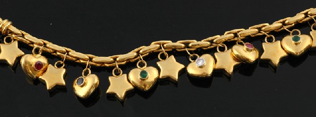 Appraisal: A gold and precious stone set charm bracelet Comprising star