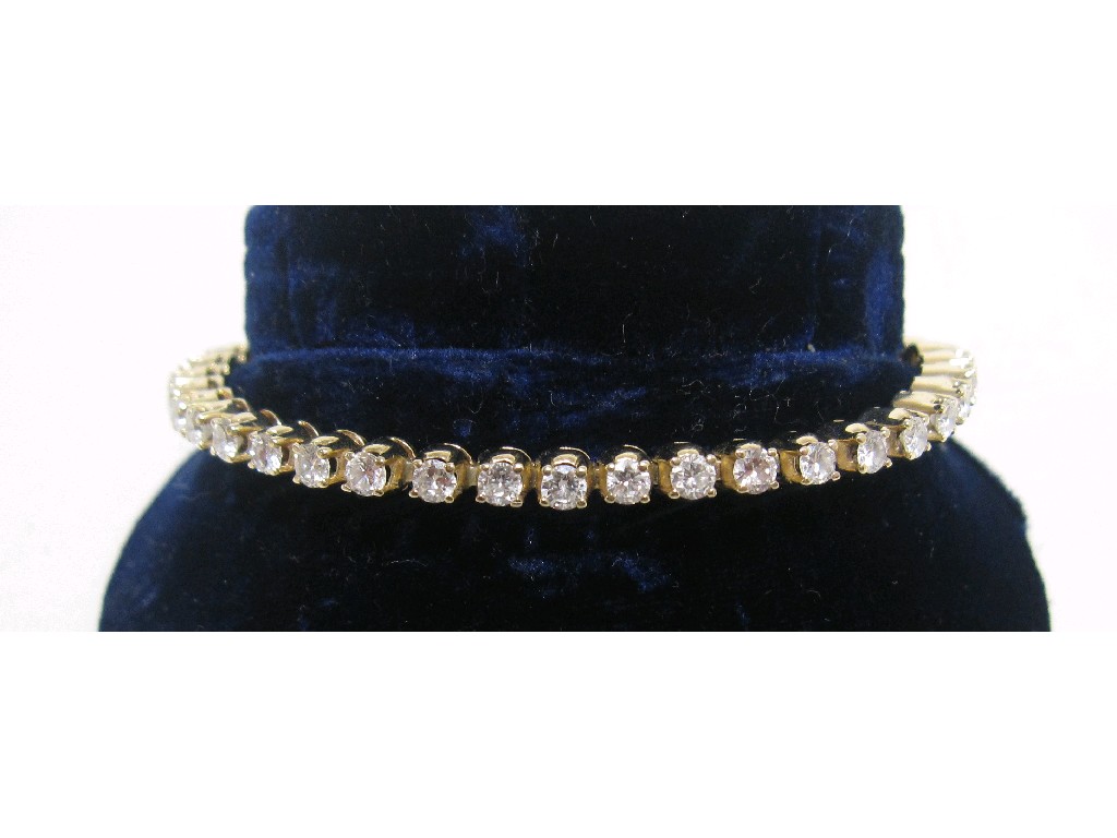 Appraisal: Eighteen carat gold diamond line bracelet with brilliant cut diamonds