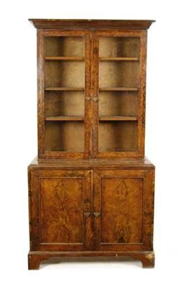 Appraisal: A walnut bookcase cabinet inlaid stringing with a pair of