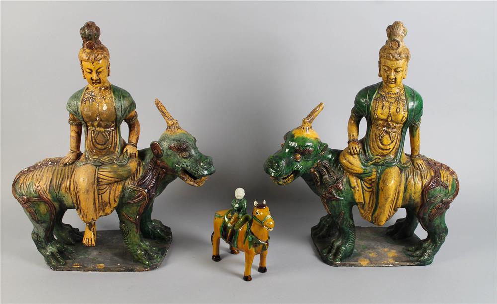 Appraisal: PAIR OF GUANYIN EACH RIDING FIGURES OF BEASTS FOO FIGURES