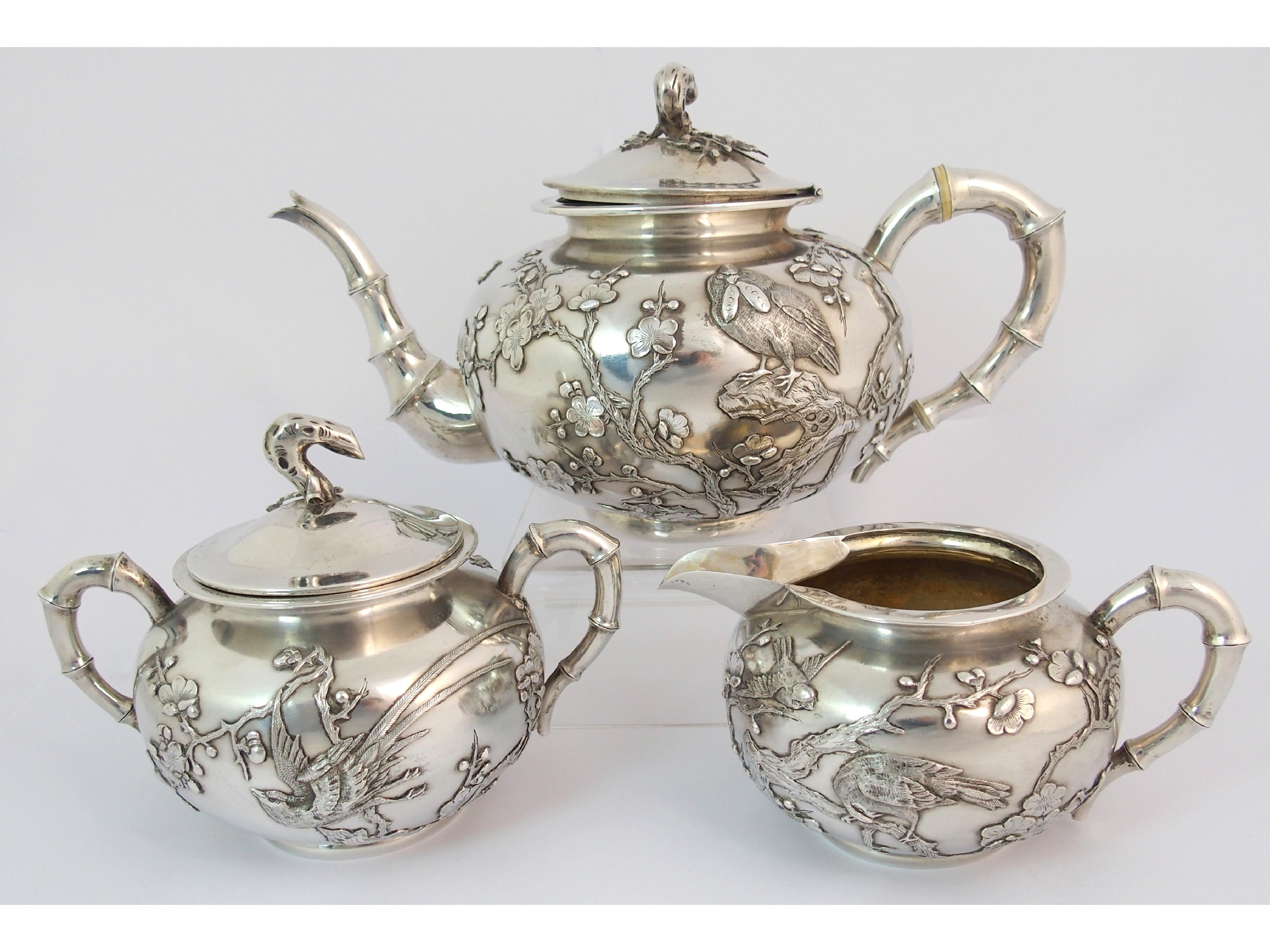 Appraisal: A Chinese silver three piece tea serviceby Wang Hing decorated