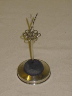 Appraisal: AN EDWARDIAN HAT PIN STAND modelled with a pair of