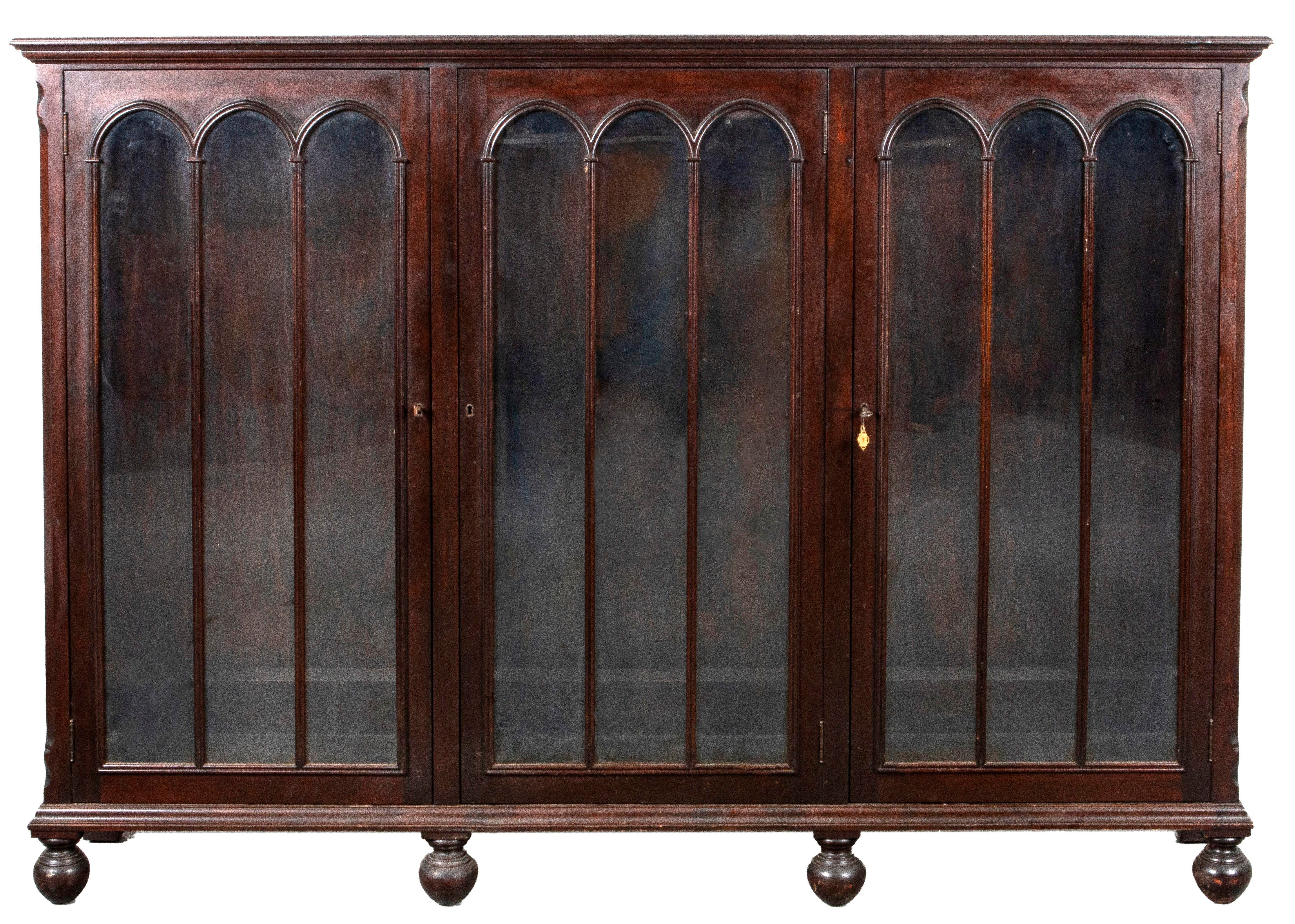 Appraisal: GOTHIC REVIVAL MAHOGANY BOOKCASE Gothic Revival mahogany bookcase with tree