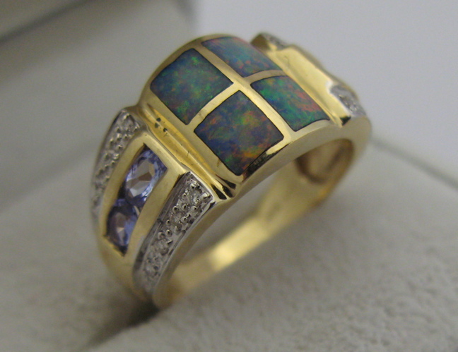 Appraisal: OPAL DIAMOND AND K GOLD RING set with four tablets