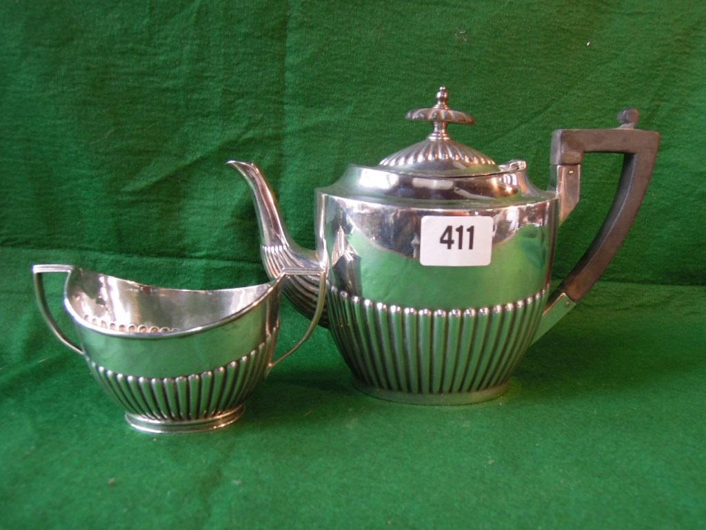 Appraisal: A silver teapot with half gadrooned sides made by Walker