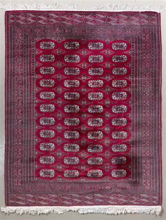 Appraisal: A Bokhara Wool Rug having repeating geometric medallions feet inches