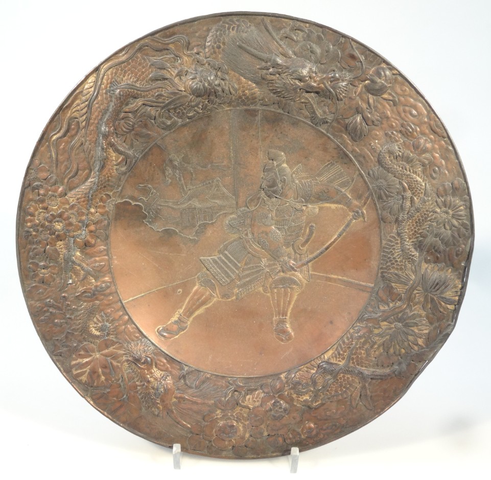 Appraisal: An oriental design copper dish of circular outline repouss decorated