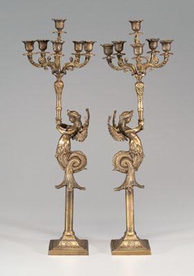 Appraisal: Pair classical bronze candelabra each depicting a winged merman holding