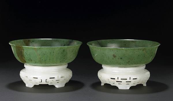 Appraisal: A pair of 'spinach' jade bowls and white jade stands