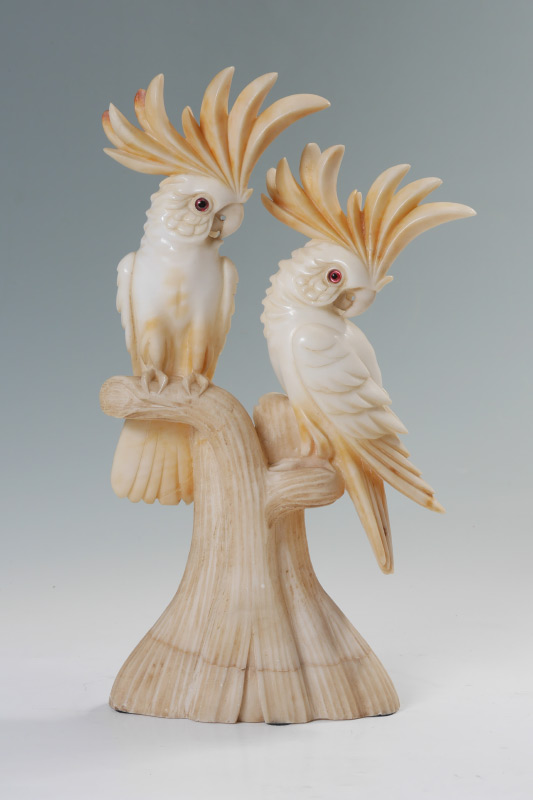 Appraisal: CARVED ALABASTER FIGURAL PARROTS Carved parrots on stump with raised