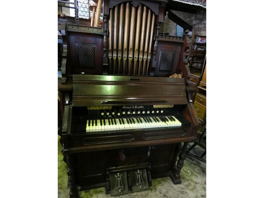 Appraisal: A late Victorian walnut cased chapel harmonium by Mason Hamlin