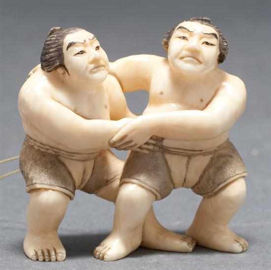 Appraisal: Japanese carved ivory netsuke pair of sumo wrestlers signed in